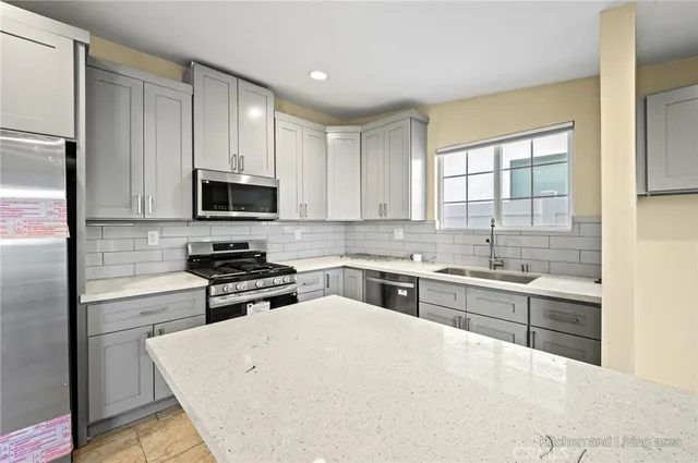 a kitchen with a refrigerator stove top oven and sink