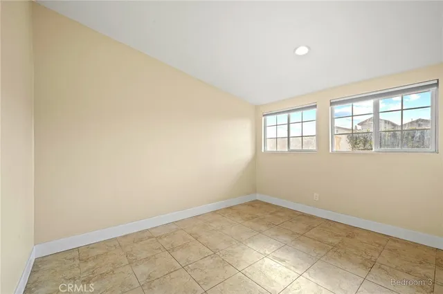 an empty room with a empty space and windows