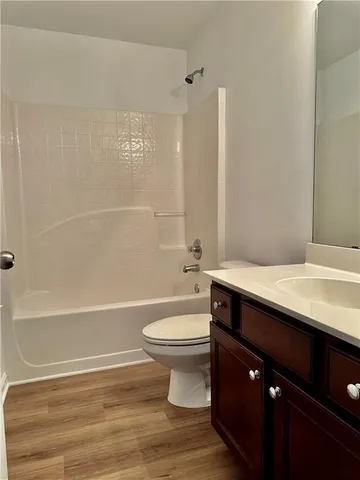 an empty room with a window and a ceiling fan