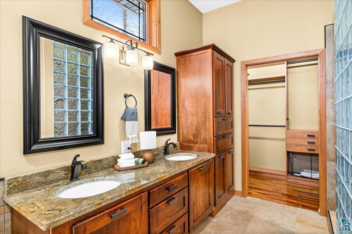92598 Spells Road Sturgeon Lake, MN 55783 - Photo 26 of 60 Bathroom with double vanity and a spacious closet