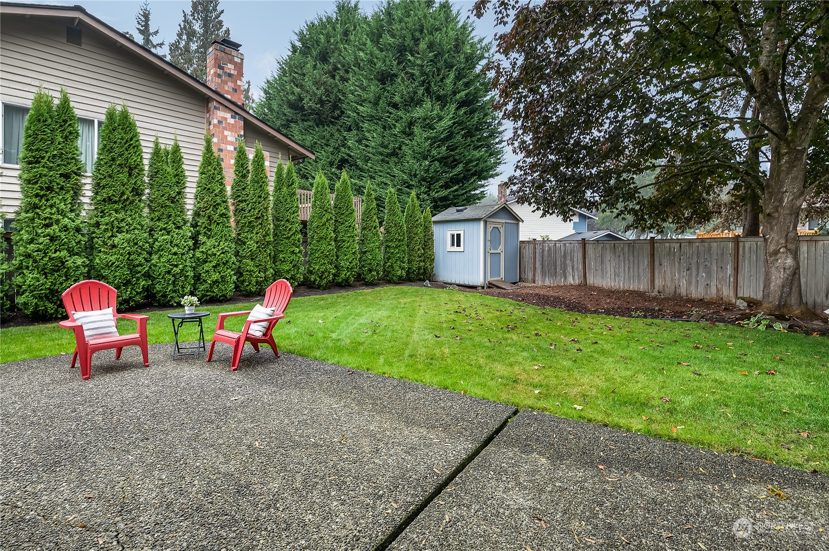 2723 166th Street Southeast Bothell, WA 98012 - Photo 26 of 31 a view of a chair and table in backyard of the house