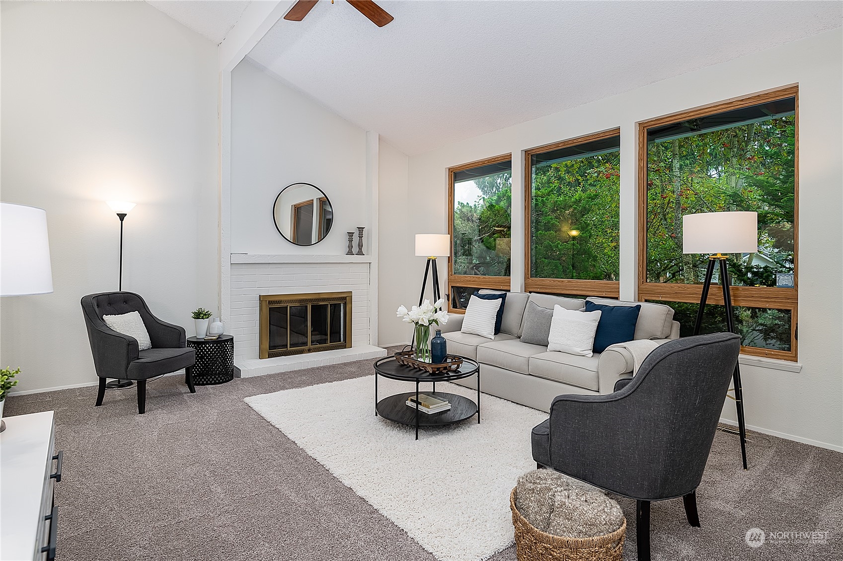 2723 166th Street Southeast Bothell, WA 98012 - Photo 4 of 31 a living room with furniture a fireplace and floor to ceiling window