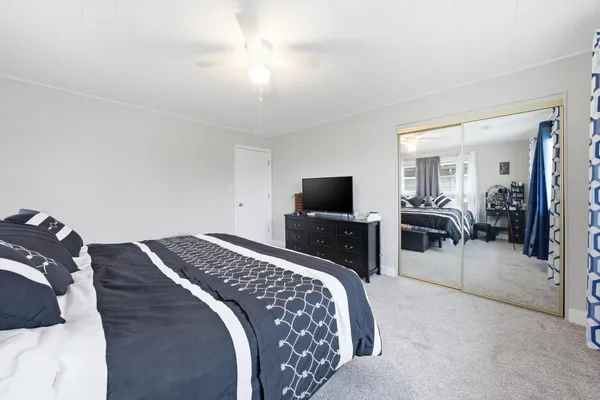 a bedroom with a bed and a television