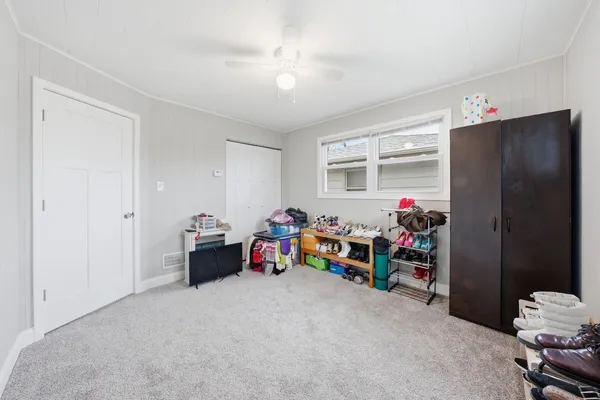 a children room with toys and a ceiling fan