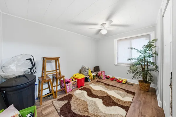 a kids room with toys and wooden floor