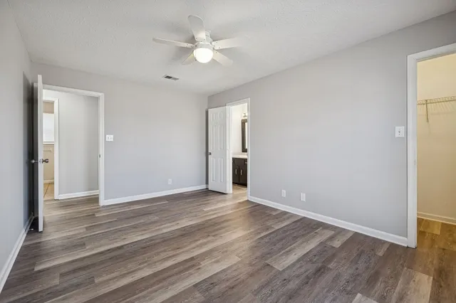 a view of an empty room with wooden floor