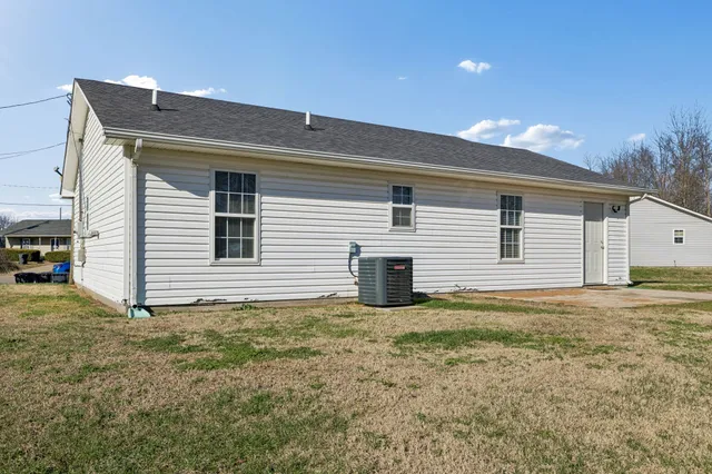 a house that has a large tree in front of it