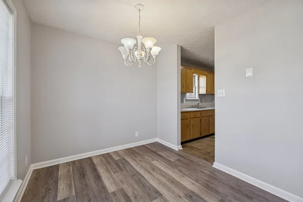 a view of kitchen with refrigerator and window