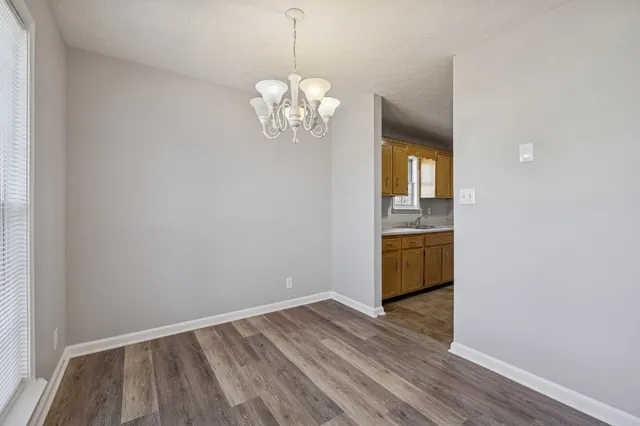 a view of kitchen with refrigerator and window