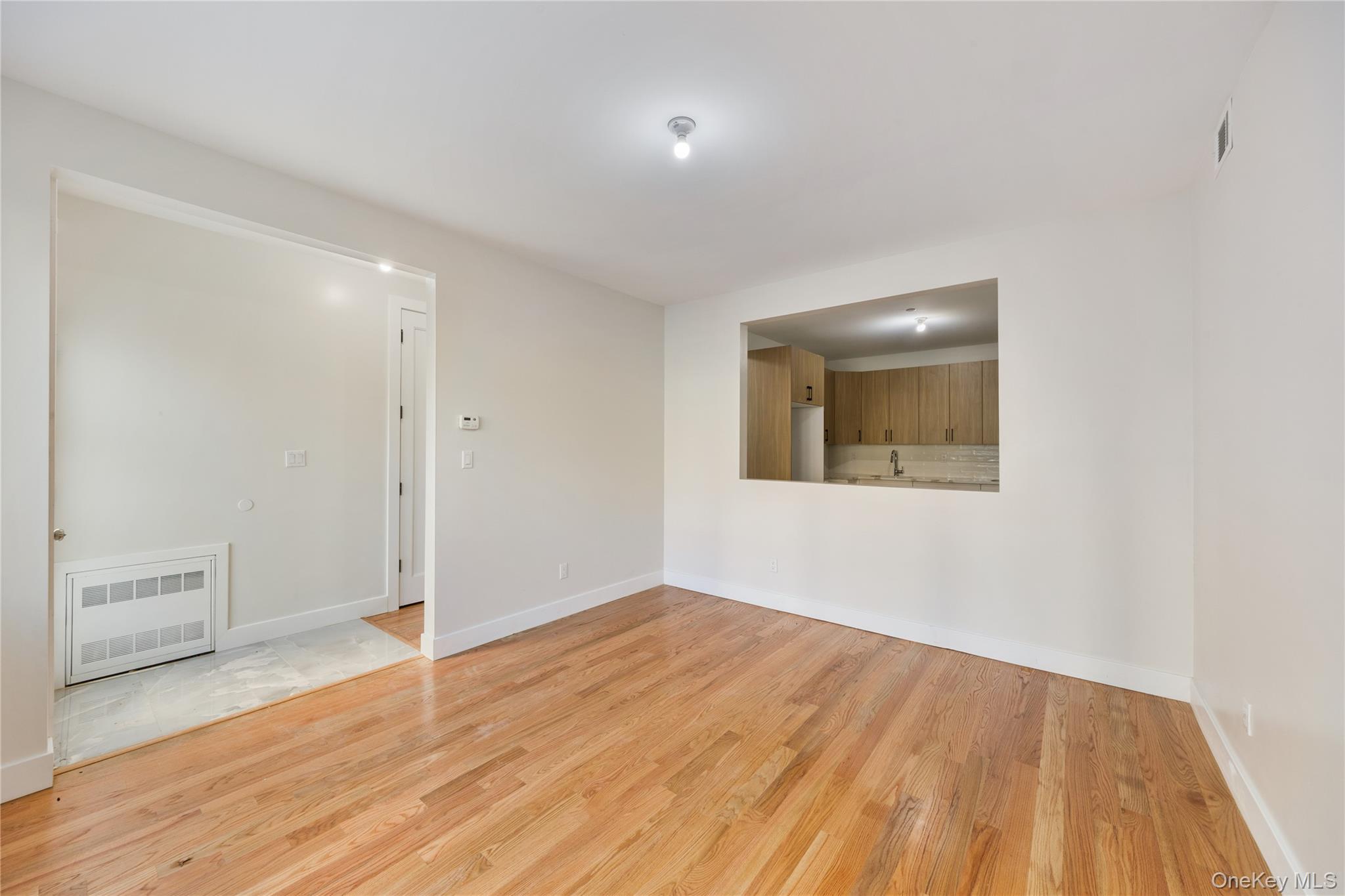 19 Lazer Court, Unit 102 Spring Valley, NY 10977 - Photo 13 of 31 an empty room with wooden floor and windows