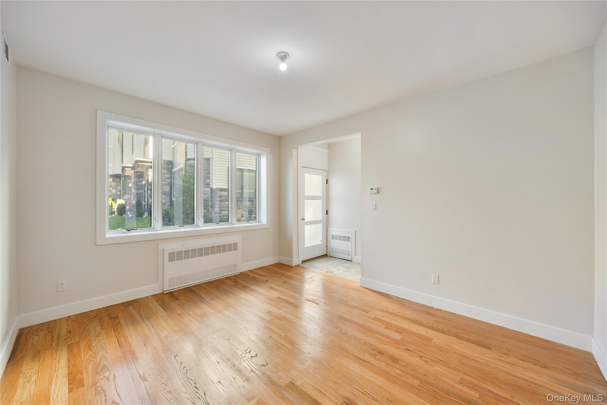 19 Lazer Court, Unit 102 Spring Valley, NY 10977 - Photo 14 of 31 a view of an empty room with wooden floor and a window