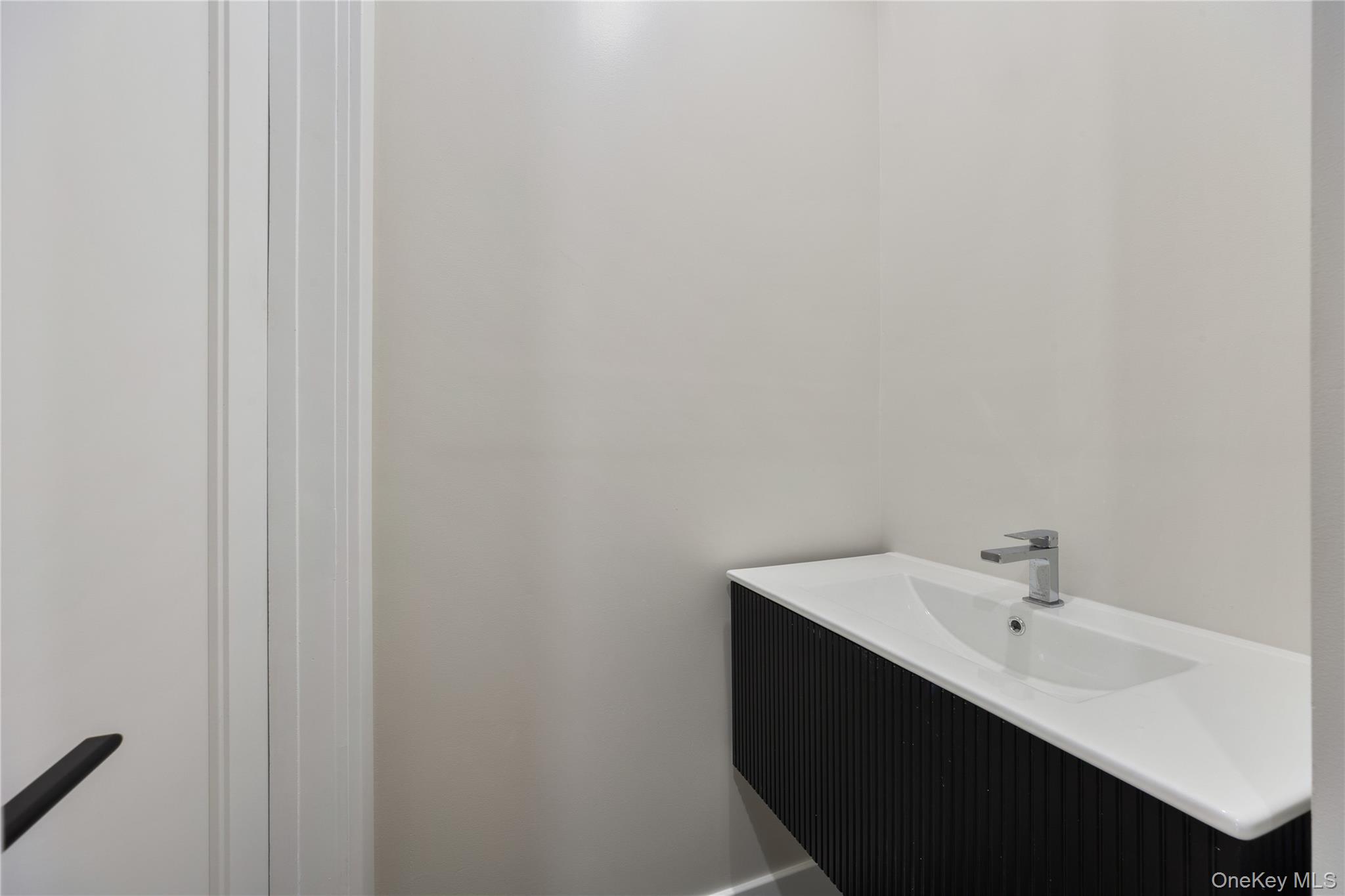 19 Lazer Court, Unit 102 Spring Valley, NY 10977 - Photo 20 of 31 a bathroom with a sink and a mirror