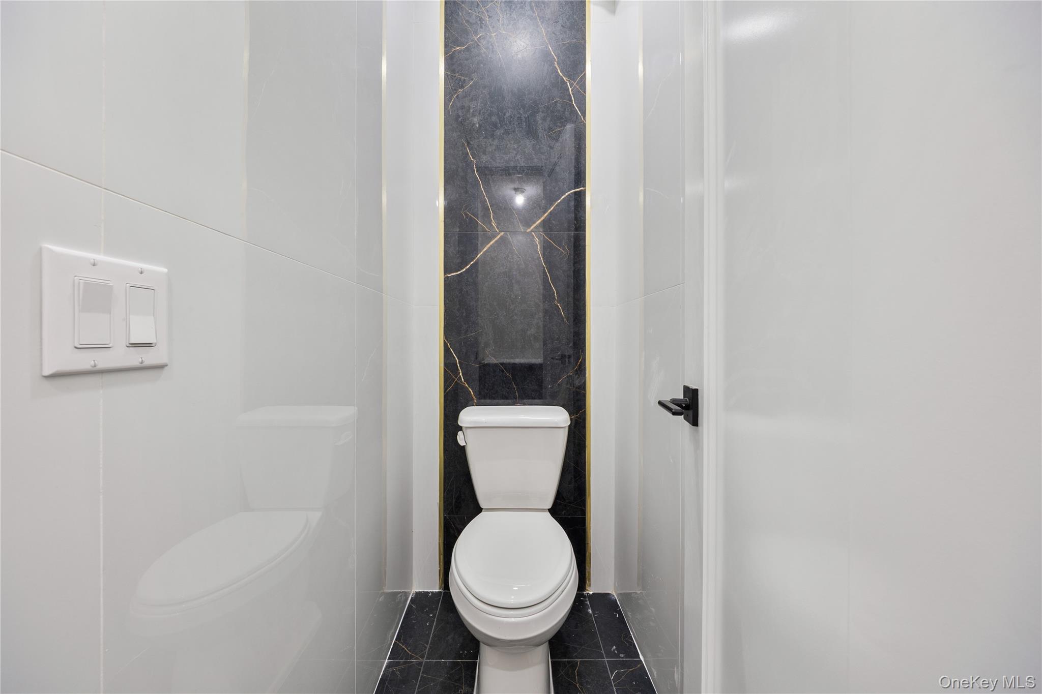 19 Lazer Court, Unit 102 Spring Valley, NY 10977 - Photo 22 of 31 a white toilet sitting in a bathroom next to a sink