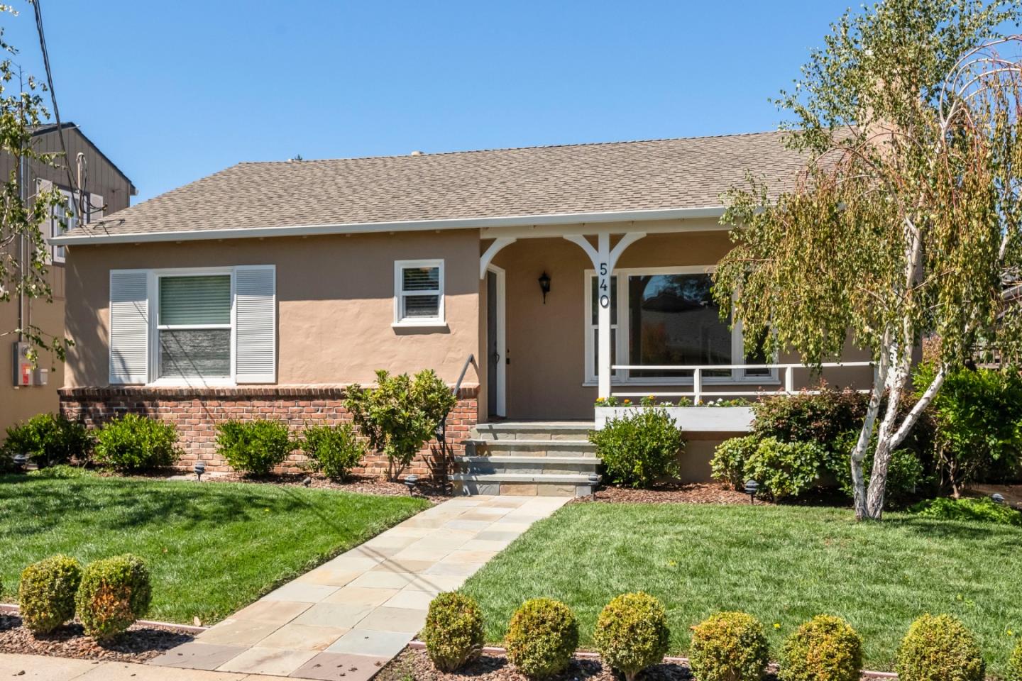 a front view of a house with garden