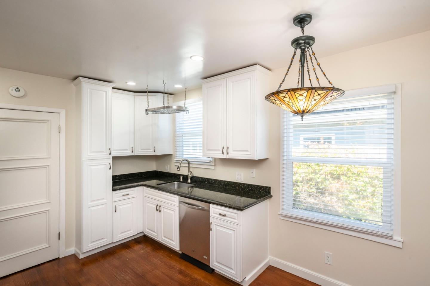540 Sylvan Avenue San Mateo, CA 94403 - Photo 12 of 23 a kitchen with a sink a window and cabinets