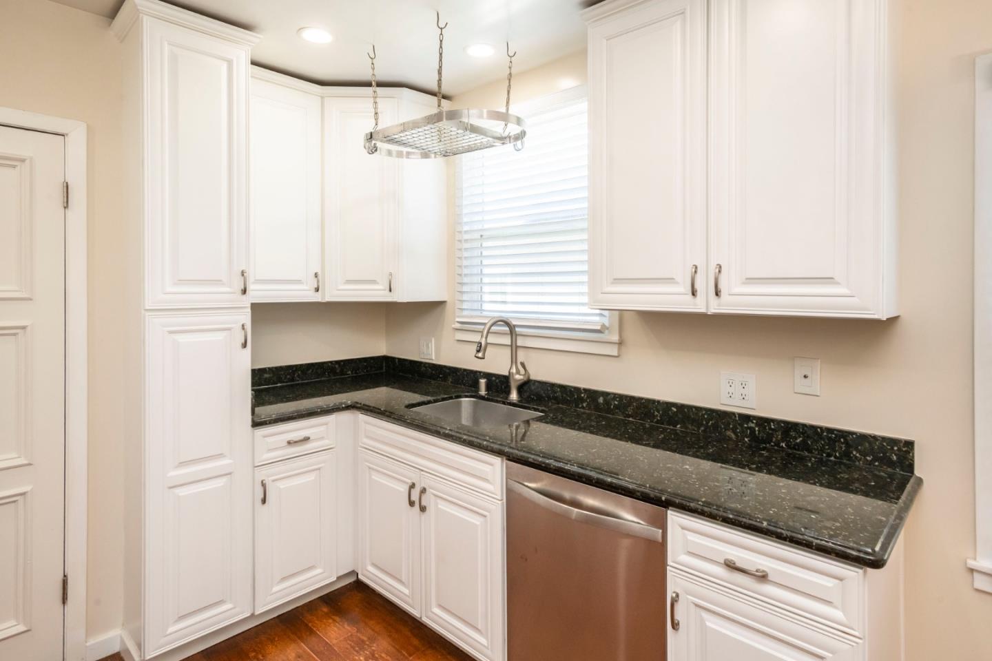540 Sylvan Avenue San Mateo, CA 94403 - Photo 13 of 23 a kitchen with granite countertop white cabinets and a sink