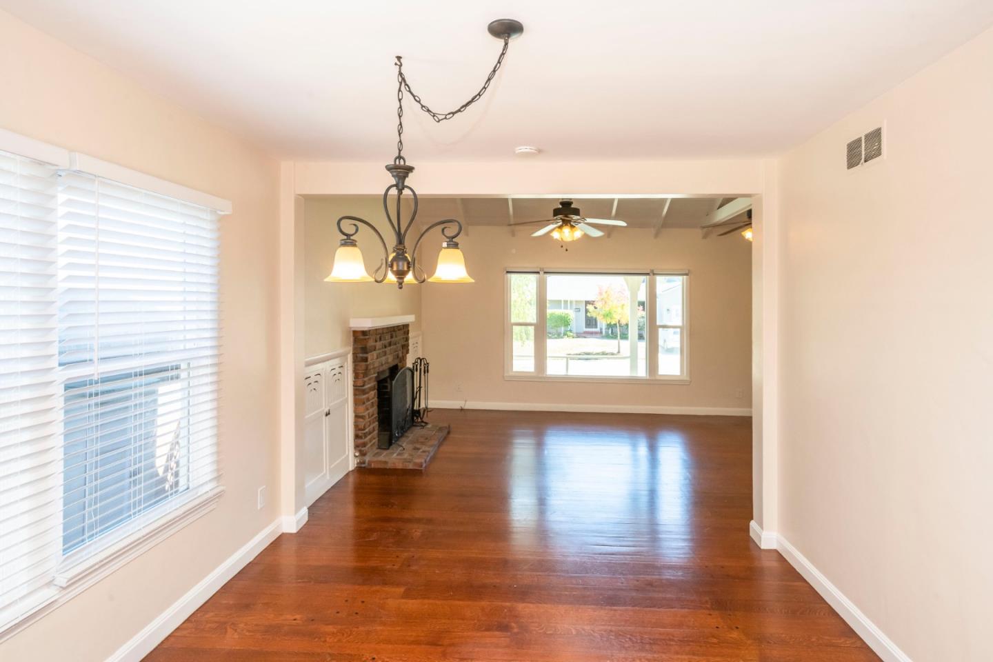 540 Sylvan Avenue San Mateo, CA 94403 - Photo 14 of 23 a view of a room with wooden floor fireplace and windows