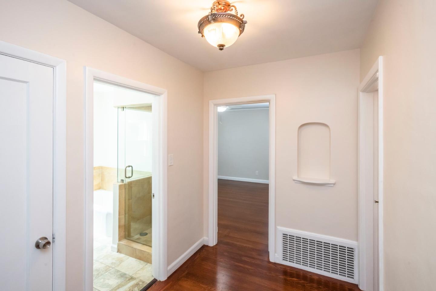 540 Sylvan Avenue San Mateo, CA 94403 - Photo 15 of 23 a view of a hallway with wooden floor