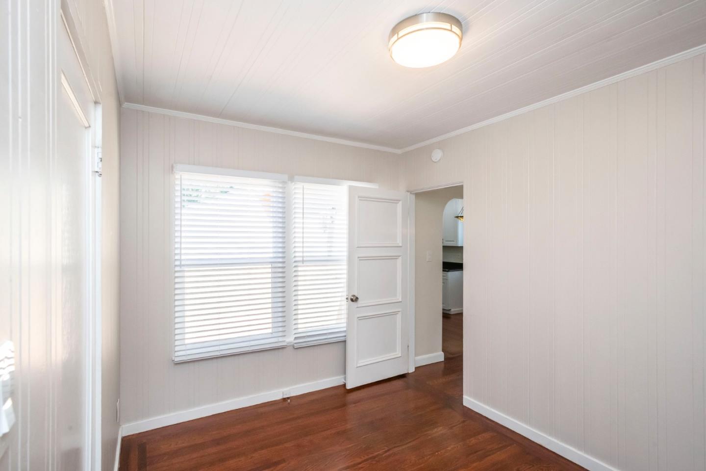 540 Sylvan Avenue San Mateo, CA 94403 - Photo 19 of 23 an empty room with wooden floor and windows