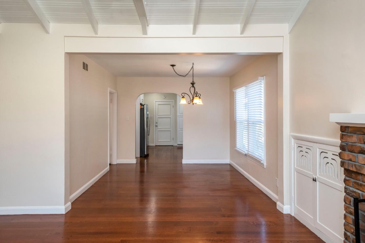 540 Sylvan Avenue San Mateo, CA 94403 - Photo 6 of 23 a view of a hallway with wooden floor and staircase