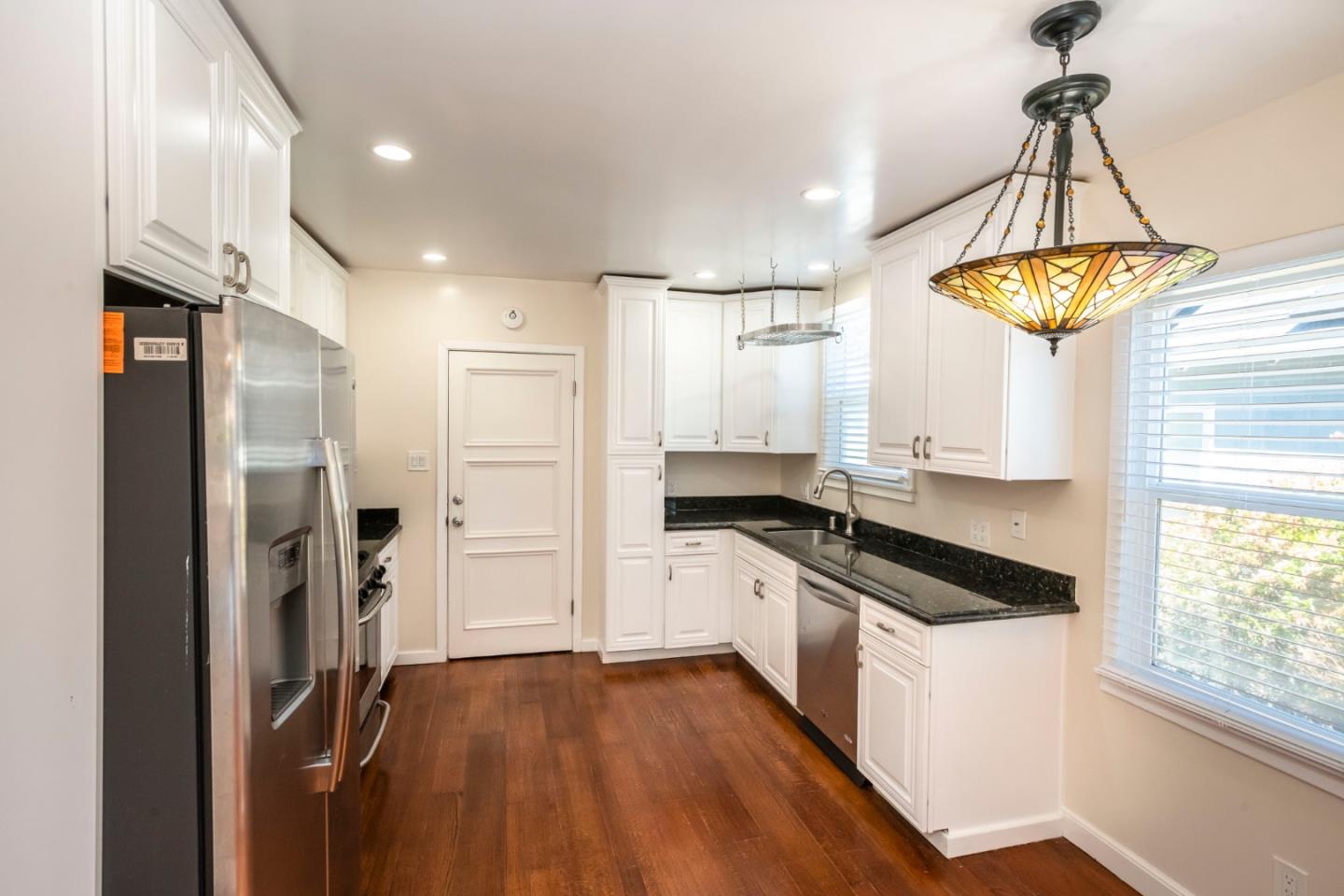 540 Sylvan Avenue San Mateo, CA 94403 - Photo 9 of 23 a kitchen with a refrigerator a sink and cabinets