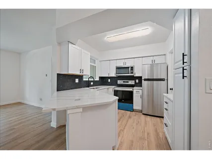 a kitchen with stainless steel appliances a refrigerator sink and stove