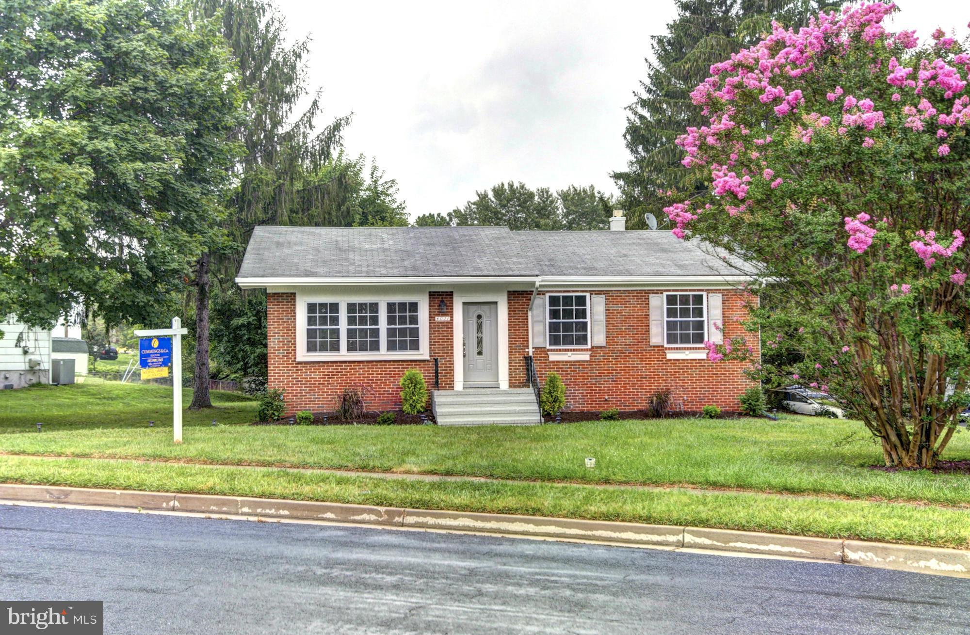 4021 Rouen Road Randallstown, MD 21133 - Photo 1 of 22 a front view of house with yard and green space