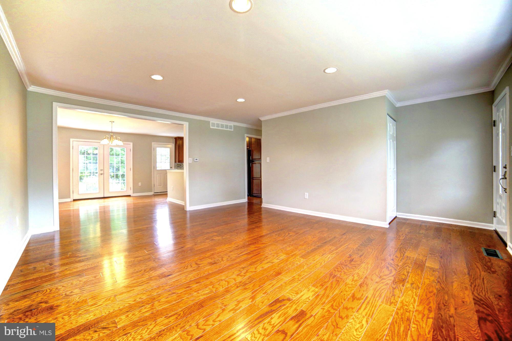 4021 Rouen Road Randallstown, MD 21133 - Photo 3 of 22 a view of empty room with wooden floor and fan