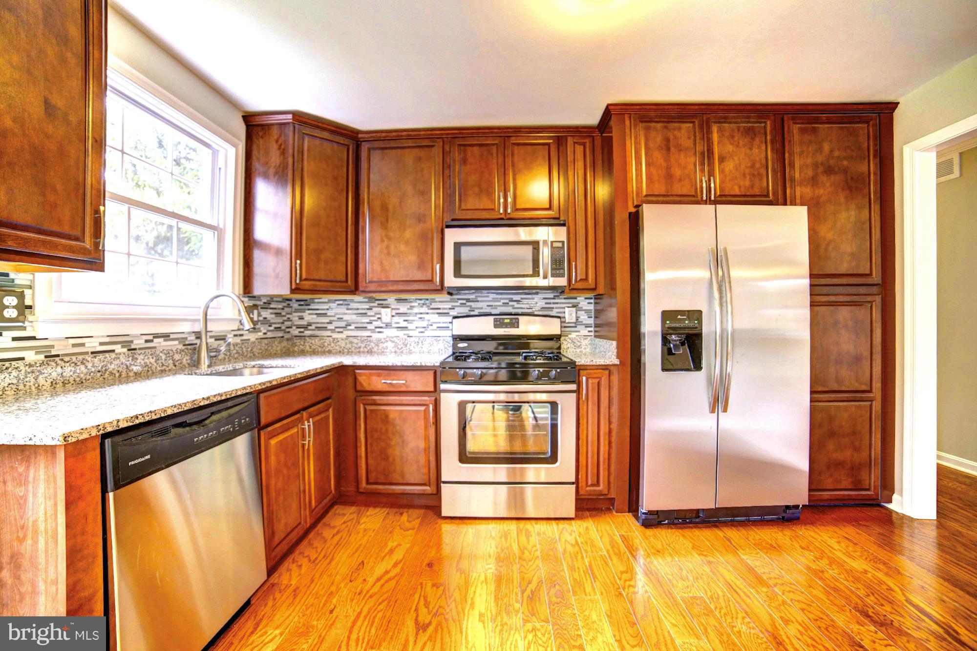 4021 Rouen Road Randallstown, MD 21133 - Photo 6 of 22 a kitchen with stainless steel appliances granite countertop a refrigerator and a sink