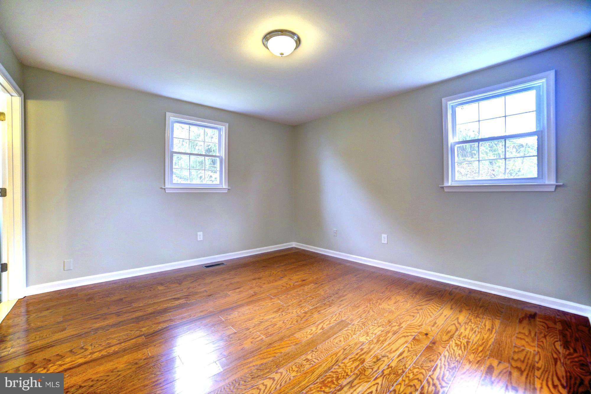 4021 Rouen Road Randallstown, MD 21133 - Photo 8 of 22 a view of an empty room with wooden floor and a window