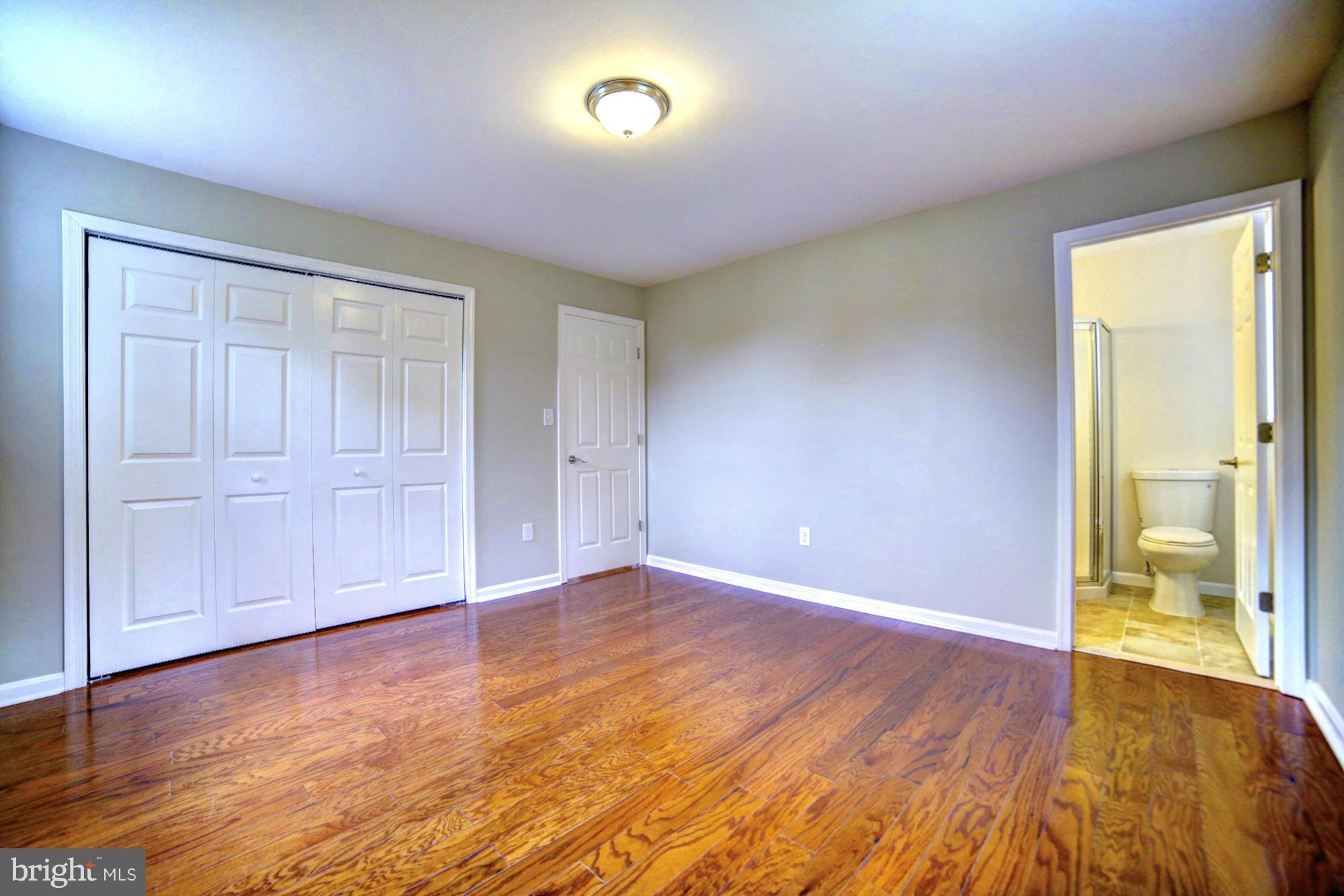 4021 Rouen Road Randallstown, MD 21133 - Photo 9 of 22 a view of an empty room with wooden floor and a window
