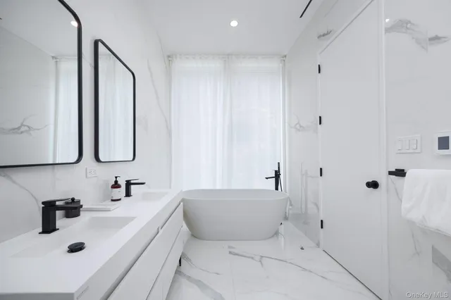 a bedroom with a large bed couch and a large window