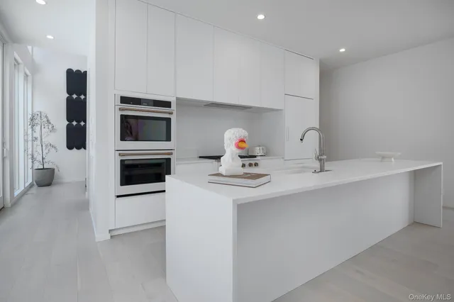 a kitchen with stainless steel appliances a sink and a refrigerator