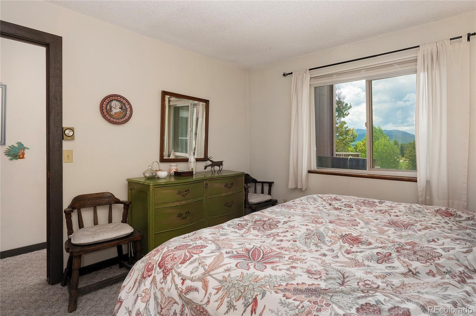 80 Gcr 838/e Meadow, Unit 2211 Fraser, CO 80442 - Photo 11 of 16 a bedroom with a bed and a window