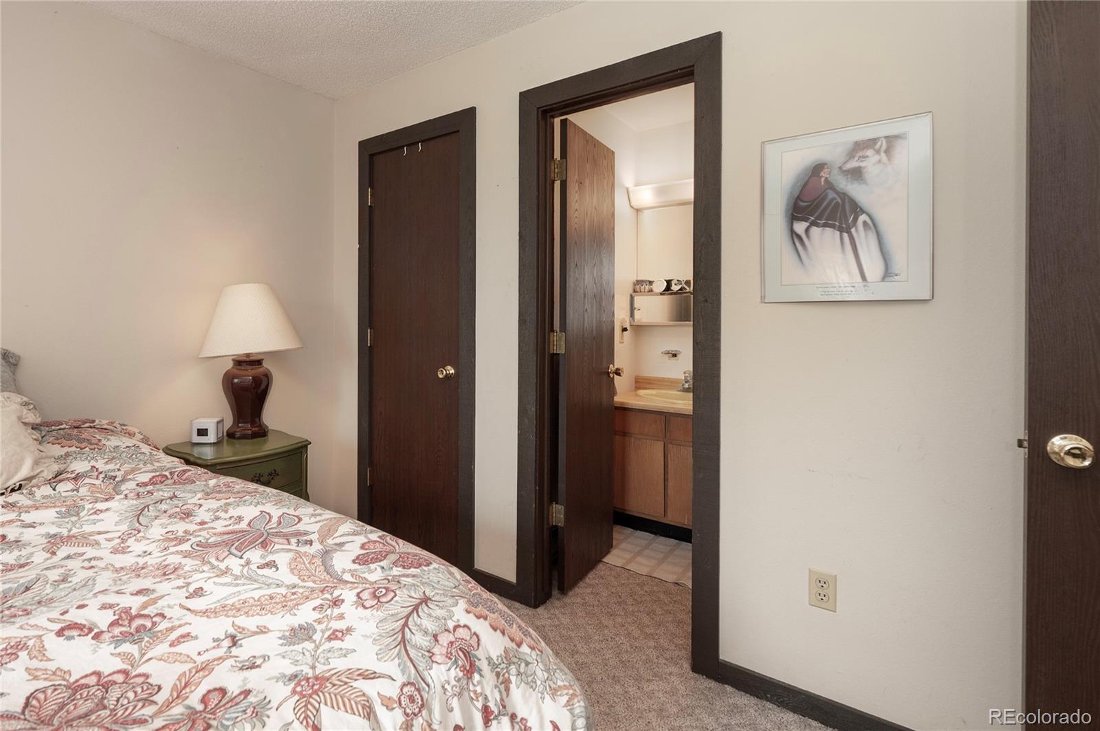 80 Gcr 838/e Meadow, Unit 2211 Fraser, CO 80442 - Photo 12 of 16 a bedroom with a bed and a painting on the wall