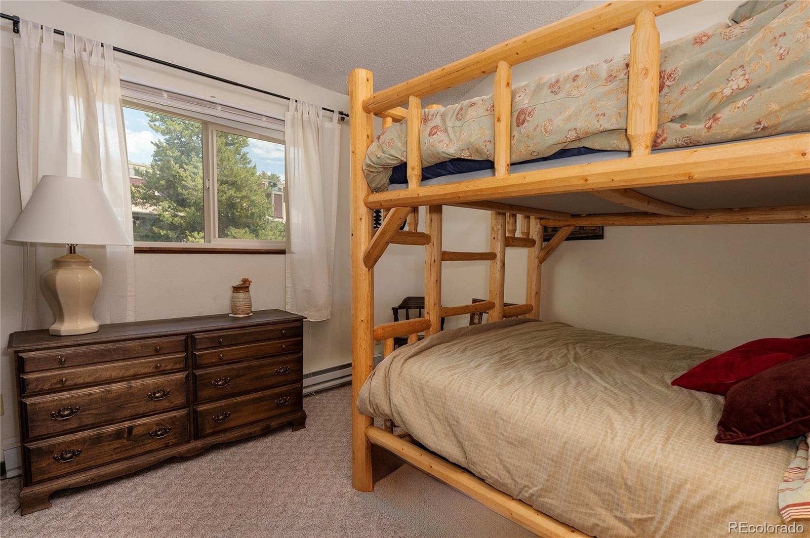 80 Gcr 838/e Meadow, Unit 2211 Fraser, CO 80442 - Photo 13 of 16 a bedroom with a bed and a window