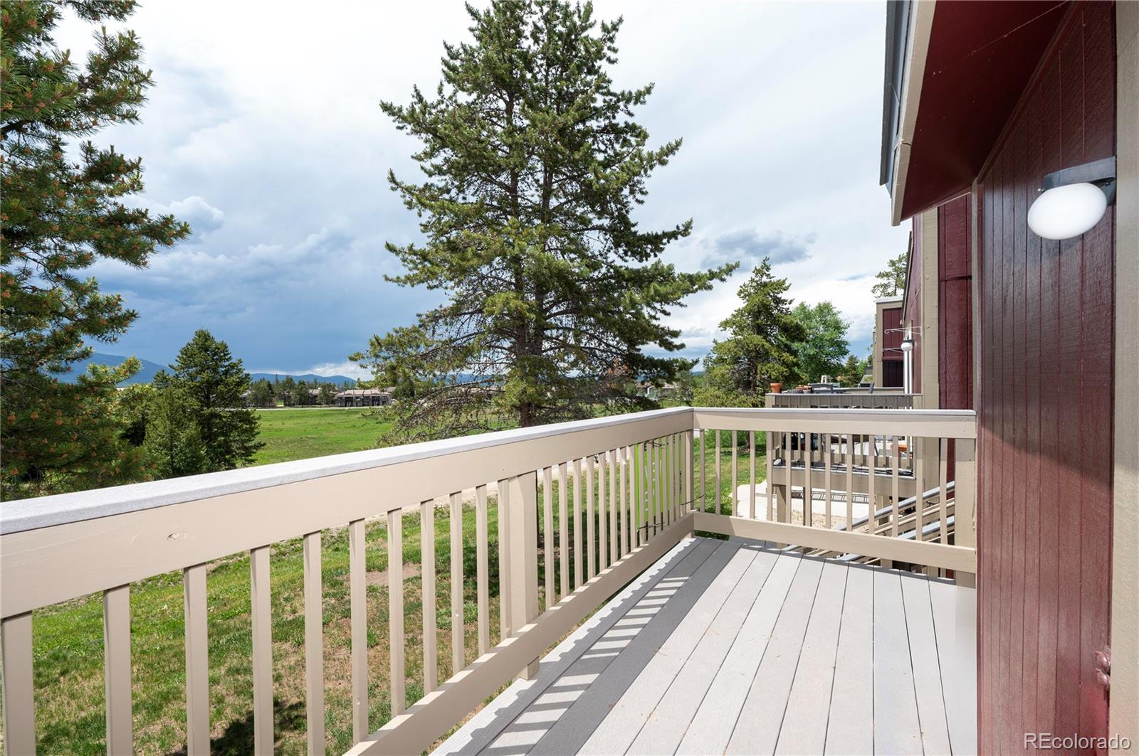 80 Gcr 838/e Meadow, Unit 2211 Fraser, CO 80442 - Photo 15 of 16 a balcony with wooden floor and fence
