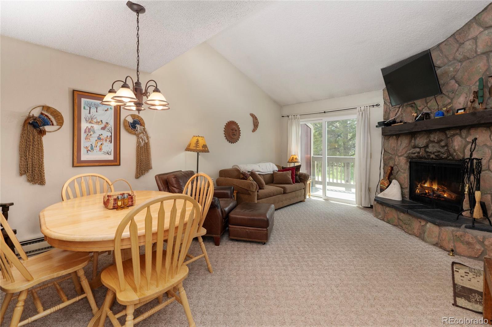 80 Gcr 838/e Meadow, Unit 2211 Fraser, CO 80442 - Photo 4 of 16 a living room with furniture a flat screen tv and a fireplace