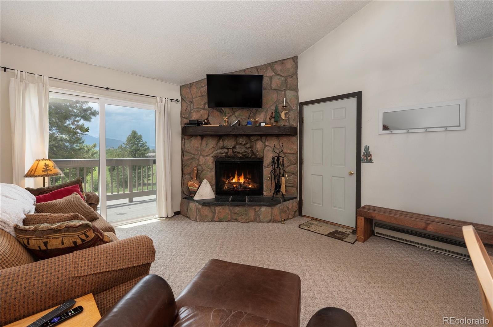 80 Gcr 838/e Meadow, Unit 2211 Fraser, CO 80442 - Photo 6 of 16 a living room with furniture and a fireplace