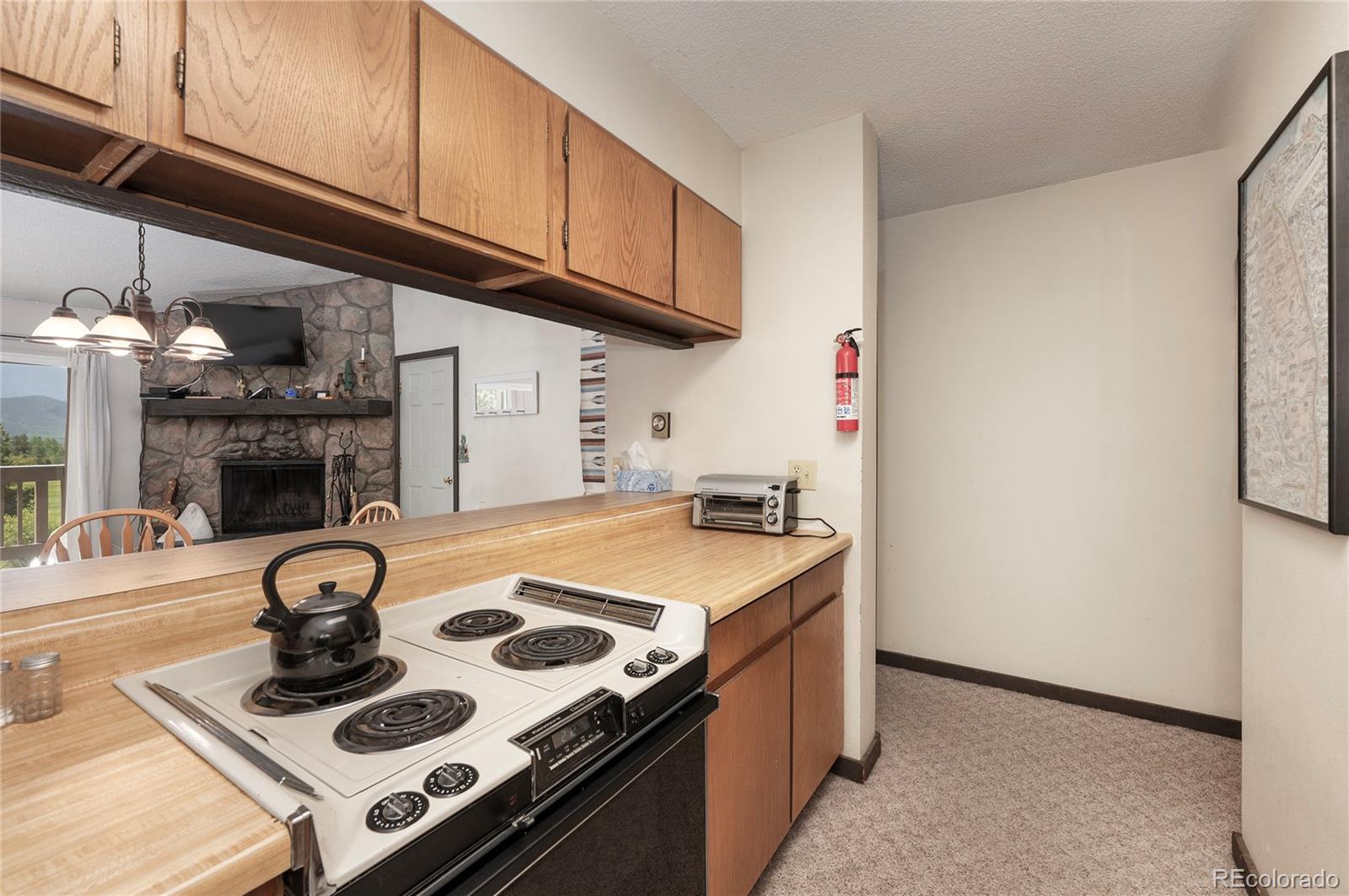 80 Gcr 838/e Meadow, Unit 2211 Fraser, CO 80442 - Photo 8 of 16 a kitchen with kitchen island stainless steel appliances granite countertop a stove and a microwave