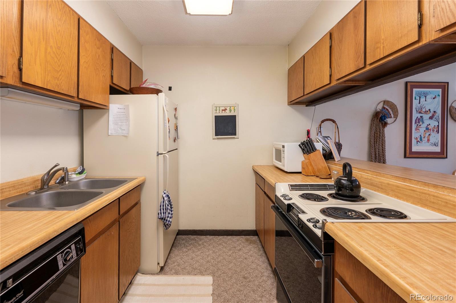 80 Gcr 838/e Meadow, Unit 2211 Fraser, CO 80442 - Photo 9 of 16 a kitchen with stainless steel appliances granite countertop a sink stove and refrigerator
