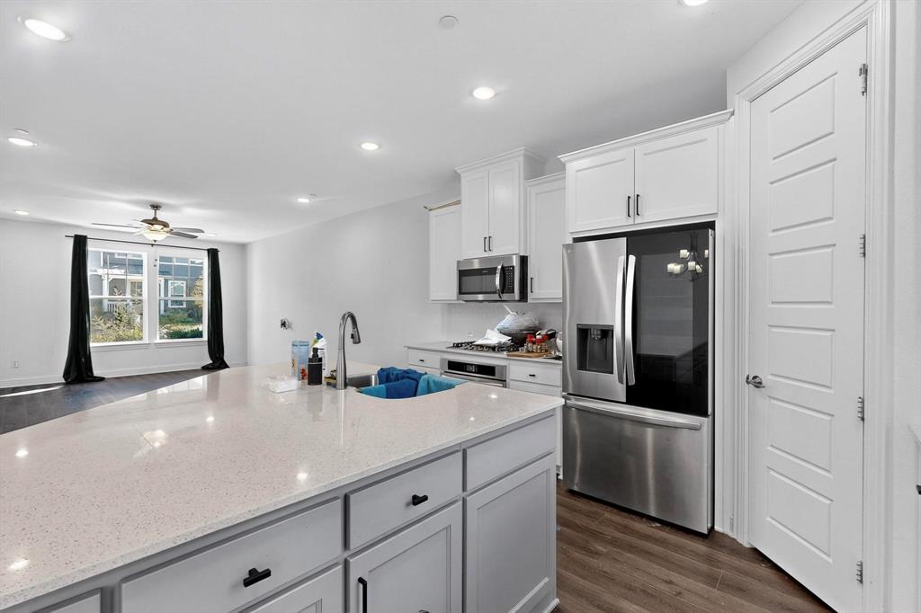 6629 Kort Street Rowlett, TX 75089 - Photo 10 of 39 a kitchen with stainless steel appliances a refrigerator sink and cabinets
