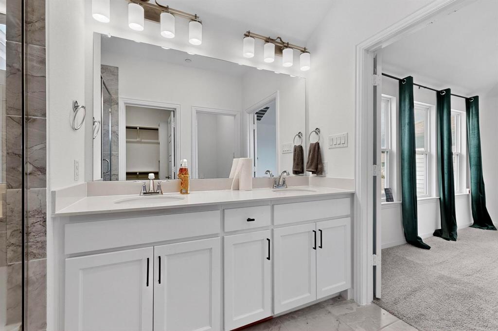 6629 Kort Street Rowlett, TX 75089 - Photo 19 of 39 a bathroom with double sink and a mirror