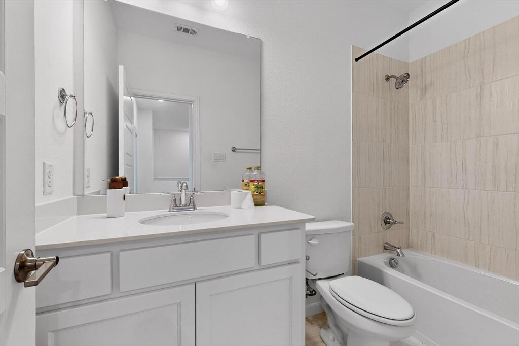 6629 Kort Street Rowlett, TX 75089 - Photo 25 of 39 a bathroom with a sink a toilet and shower