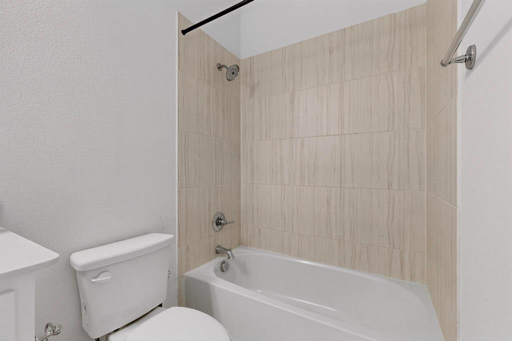 6629 Kort Street Rowlett, TX 75089 - Photo 26 of 39 a white bath tub sitting next to a white toilet and sink