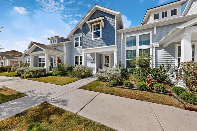 a front view of a house with yard and porch