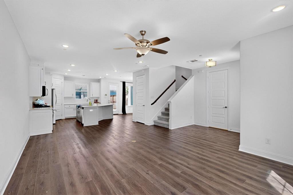 6629 Kort Street Rowlett, TX 75089 - Photo 7 of 39 a view of an empty room with wooden floor and a ceiling fan