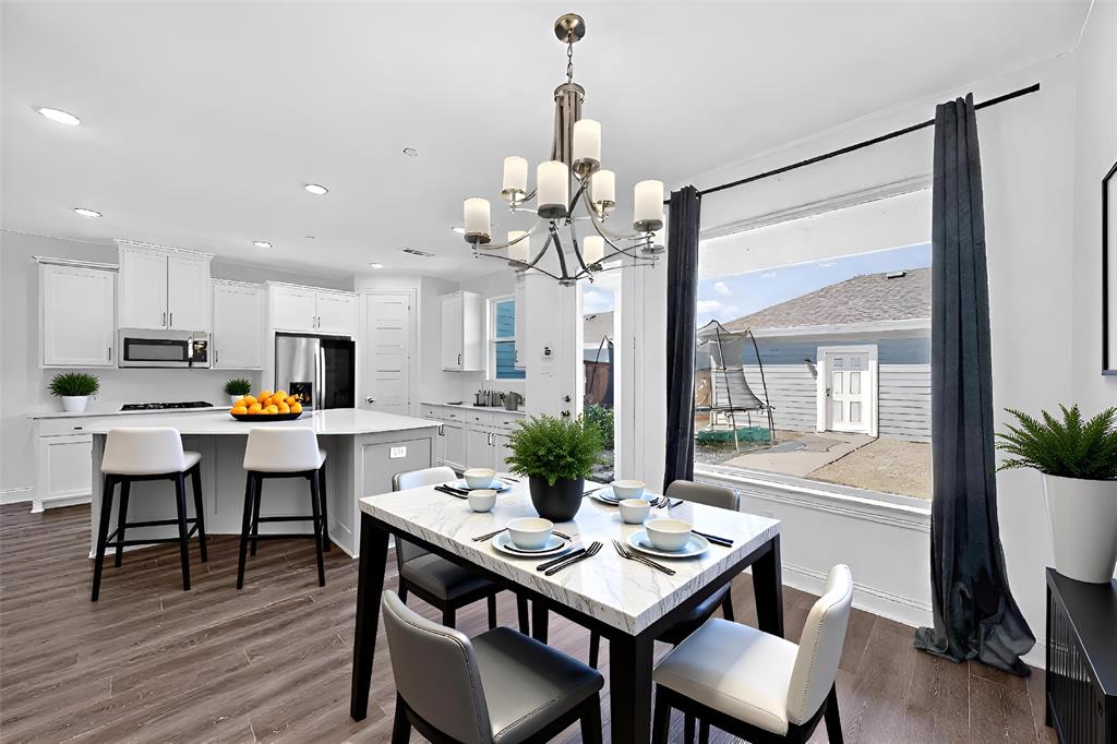 6629 Kort Street Rowlett, TX 75089 - Photo 8 of 39 a view of a dining room with furniture window and wooden floor
