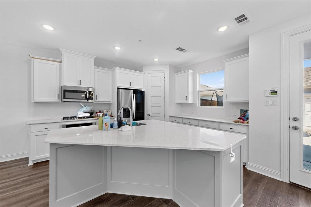 6629 Kort Street Rowlett, TX 75089 - Photo 9 of 39 a kitchen with appliances a sink cabinets and wooden floor
