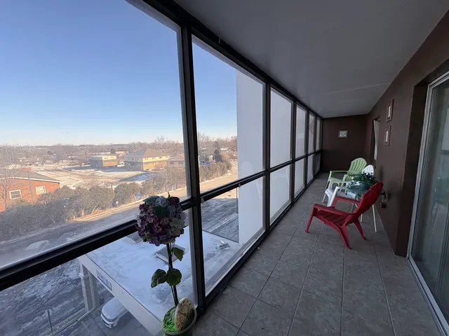 a view of two chairs in the balcony